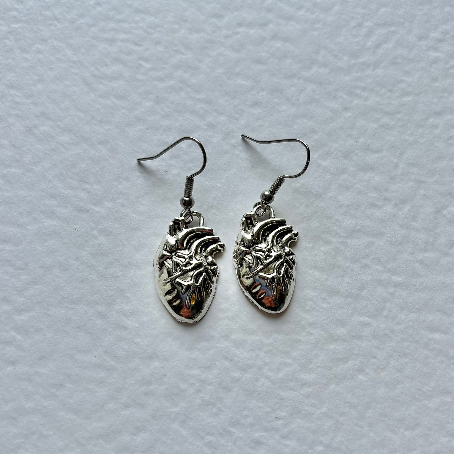 Silver or red anatomical heart dangle earrings