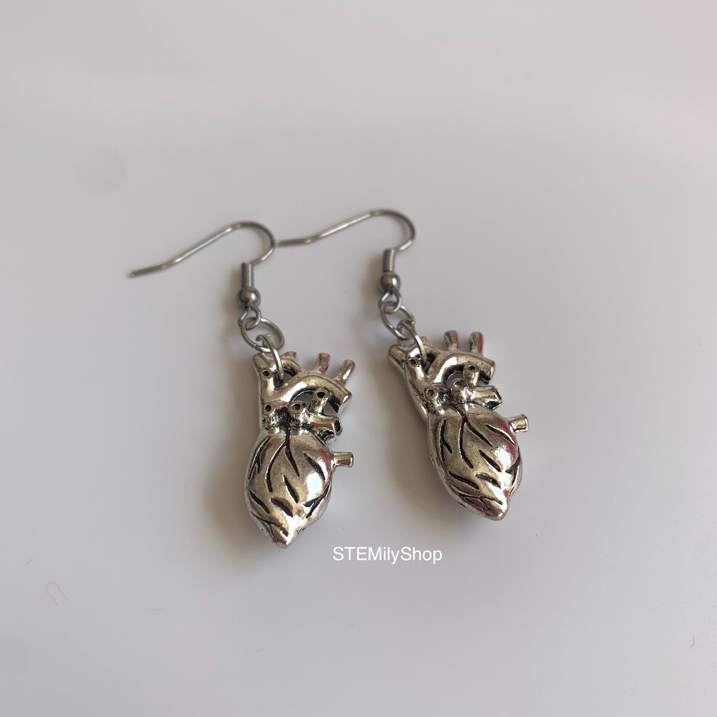 Silver anatomical heart biology dangle earrings on hypoallergenic surgical steel hooks