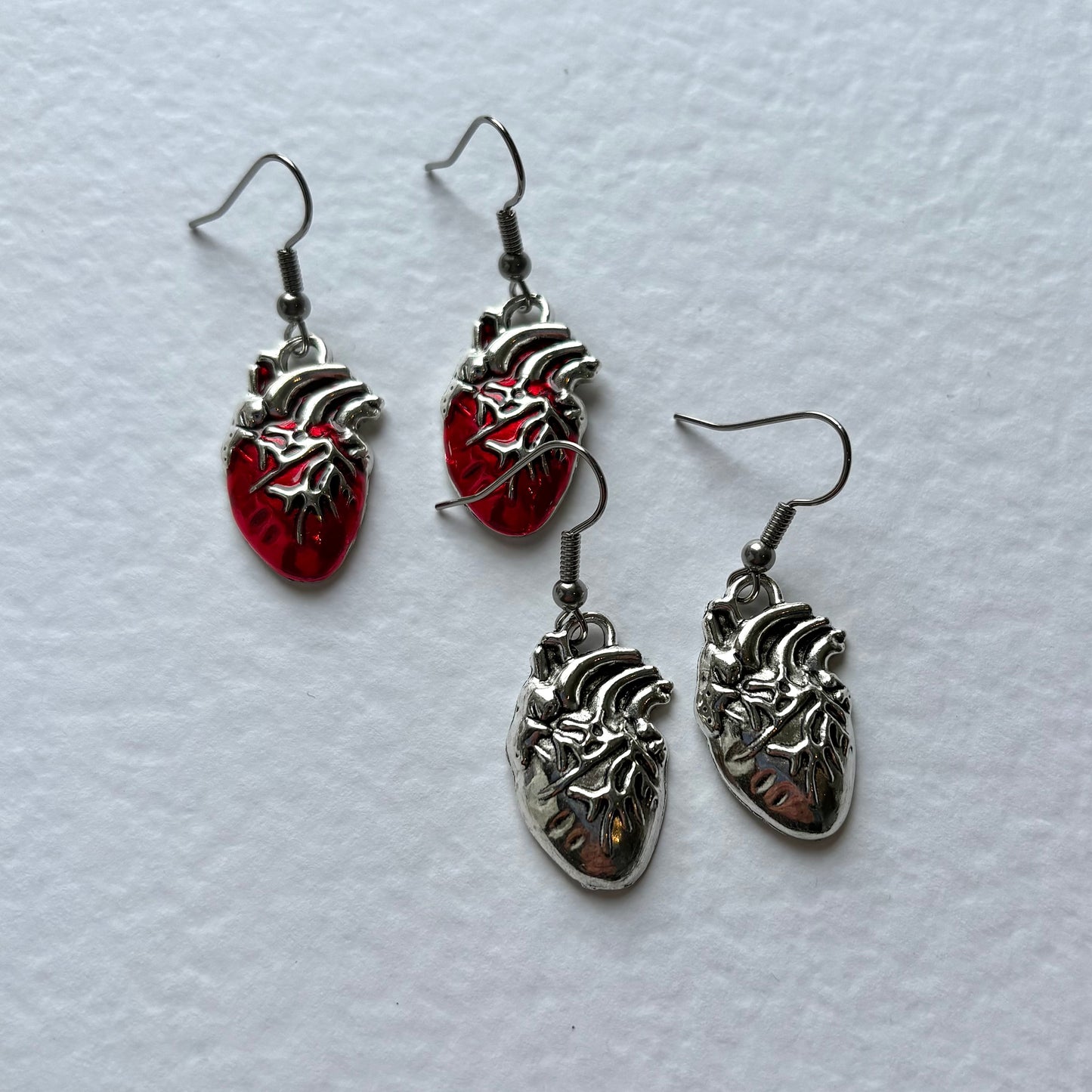 Silver or red anatomical heart dangle earrings