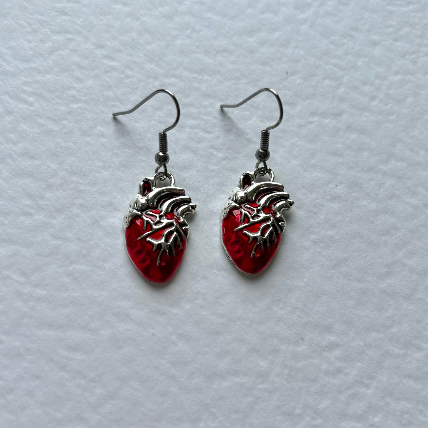 Silver or red anatomical heart dangle earrings